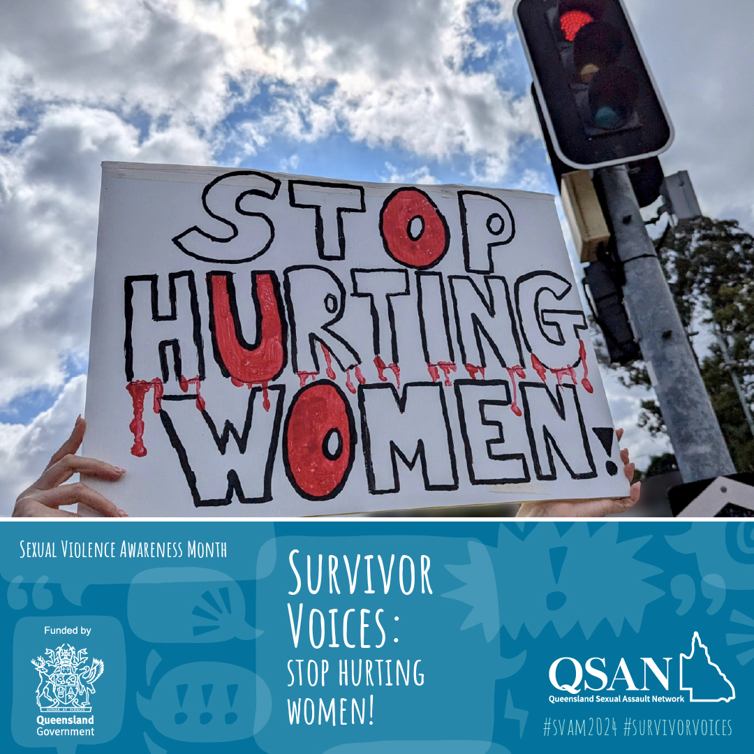 Hands holding up a sign next to a traffic light on red. The words on the sign say ‘Stop hurting women’.