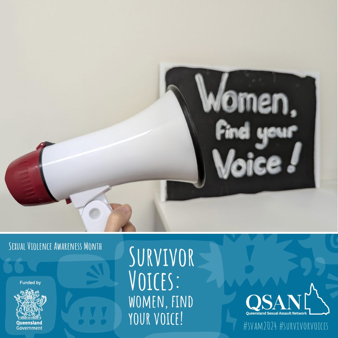 A hand holds up a megaphone in front of a black sign with the words ‘Women, find your Voice!’.